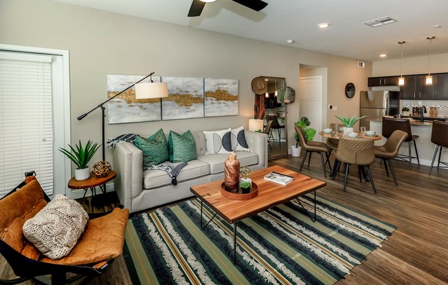 Living room decor with couch and frames at Level 25 at Sunset by Picerne, Las Vegas, NV