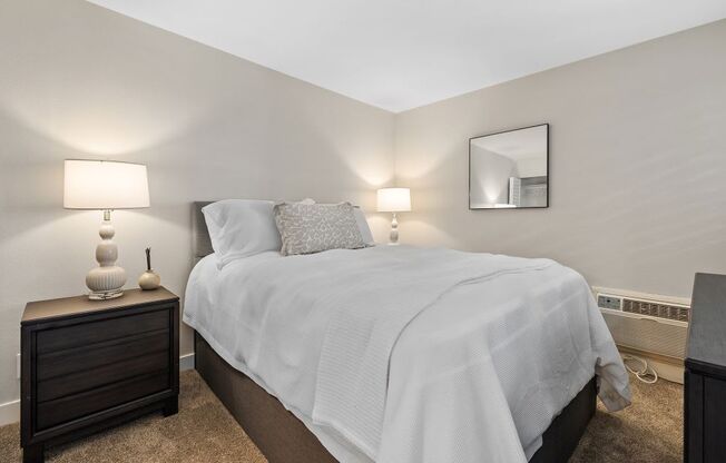 a bedroom with a bed and two night stands