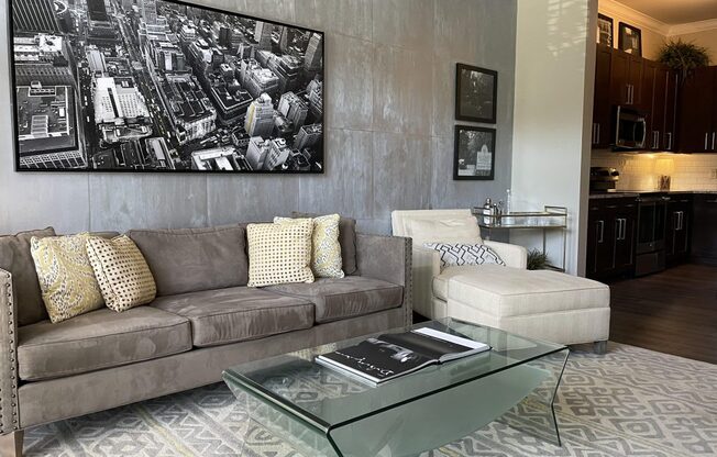 a living room with a couch and a glass table