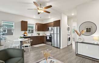 A modern kitchen with a dining table and chairs.