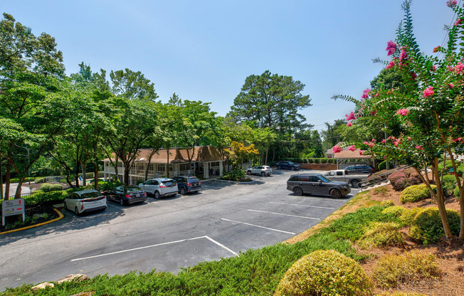 a parking lot with cars parked in front of a building