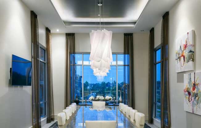 a dining room with a table and chairs and a large window