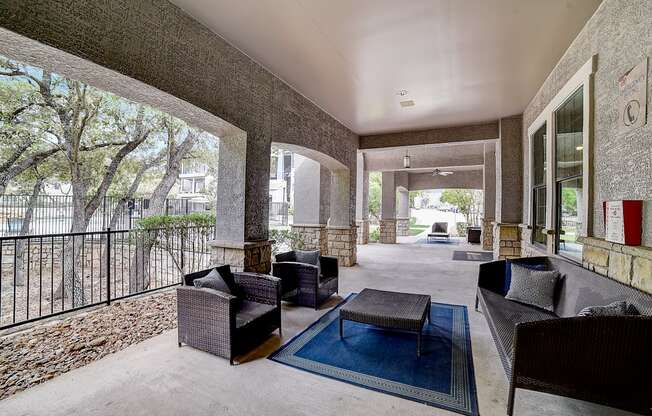 a large patio with furniture and a pool in the background