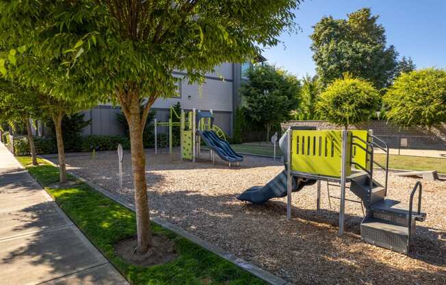 a playground with a yellow bench and a blue slide