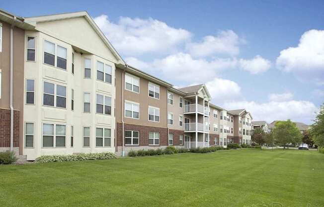 Apartment complex with a green lawn in front.