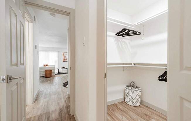 A hallway with a white door and a white bag on the floor.