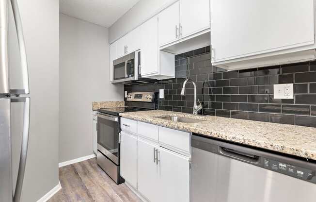 Kitchen with stove and dishwasher at Eddingham in Lawrence, KS