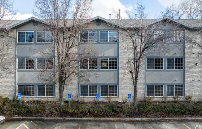 an exterior view of a building with trees in front of it