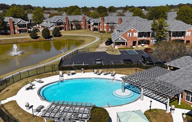 aerial view of an outdoor pool and pond