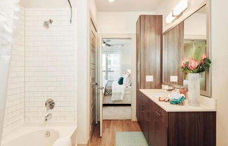 Ensuite Bathroom with Cabinet Storage and Soaking Tub