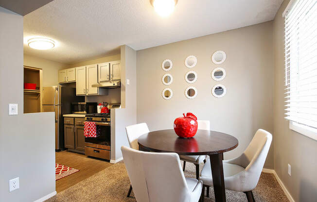 a dining room with a table and chairs and a kitchen