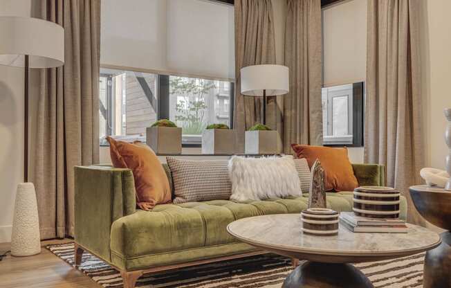 a living room with a green couch and a table