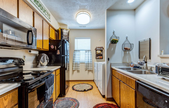 a kitchen with a stove and a sink and a refrigerator