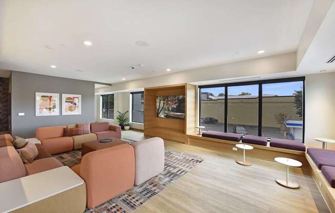 A modern living room with a large window and a wooden floor.