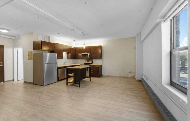 A kitchen with a refrigerator, stove, and sink.