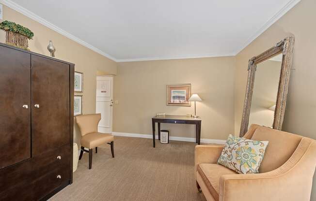 a living room with a couch and a dresser and a mirror