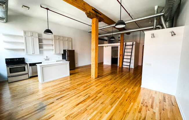 A kitchen with wooden floors and white walls.