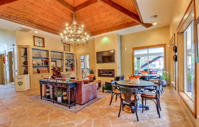 a dining room and living room with a table and chairs and a fireplace