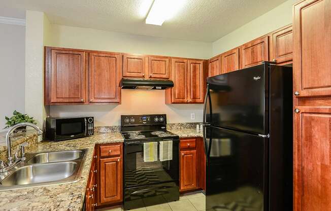 UG2 - Kitchen with black appliances at Audubon Oaks, Florida