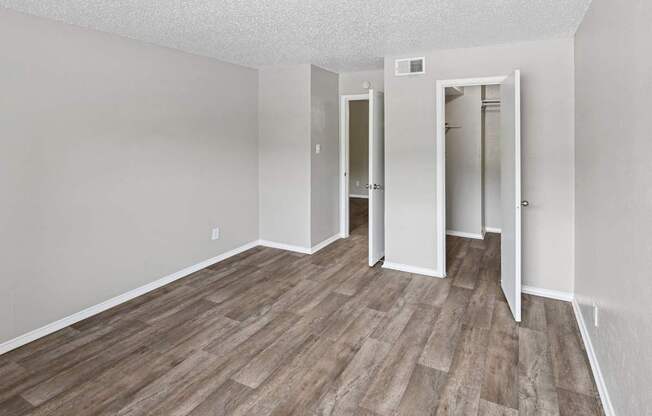 A room with wood flooring and white walls.