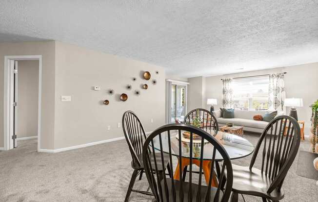A dining room with a table set for four.