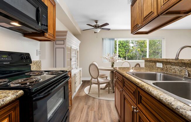 a kitchen with a stove top oven and a sink