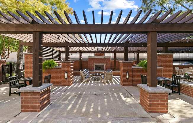 A patio with a table and chairs under a wooden pergola at Prairie Crossing, Texas