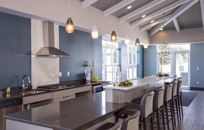 Clubroom Kitchen Area with Expansive Island and Ample Barstool Seating