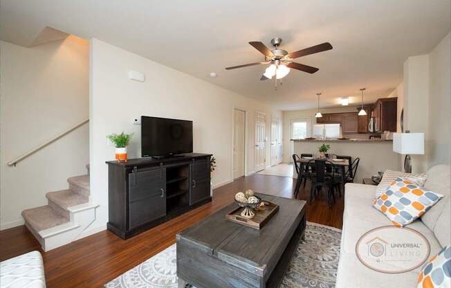 A living room with a television, a couch, and a coffee table.