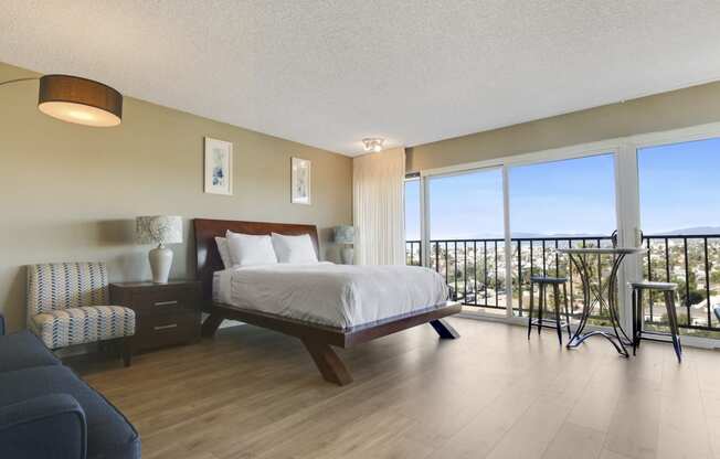 Sleeping area with wood-inspired floors, Large Windows, glass sliding door, balcony with Spectacular Views