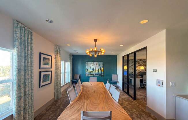 A dining room with a wooden table and chairs.
