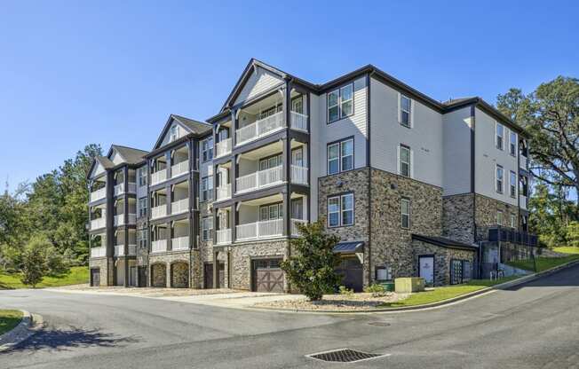 Side view of our apartment buildings with balconies and garage parking spots at Evergreen at Southwood in Tallahassee, FL