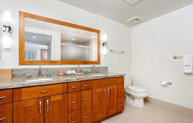 a bathroom with a large vanity and a toilet