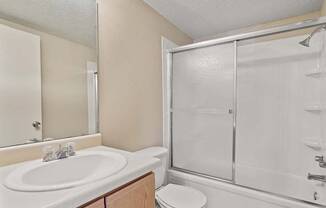 One bedroom bathroom with a sink toilet and shower