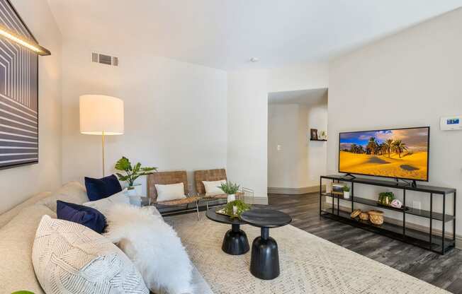 a living room with a couch and a tv at Mirasol Apartments, Nevada, 89119