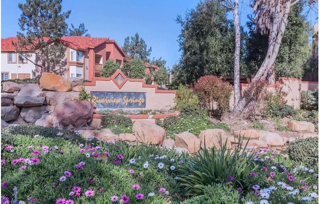 a garden with rocks and flowers in front of a house at Riverview Springs, Oceanside