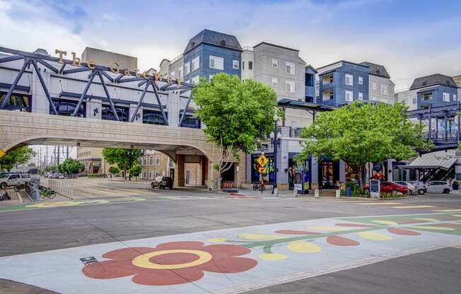 a city street with buildings and a sign on the ground