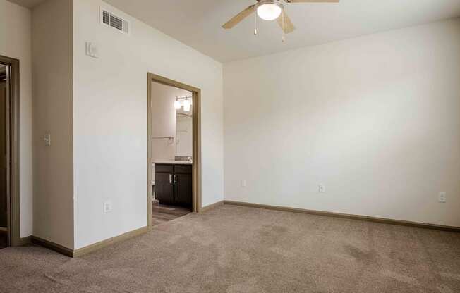 an empty bedroom with a ceiling fan at Parc at Bentonville Apartments in Bentonville, AR