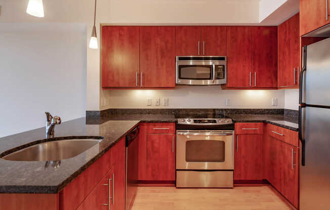 Kitchen with Cherry Wood Cabinets and Granite Countertops