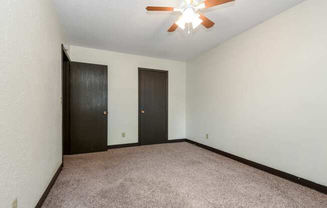 White Bear Lake, MN White Bear Terrace Apartments.  an empty room with a ceiling fan and two doors