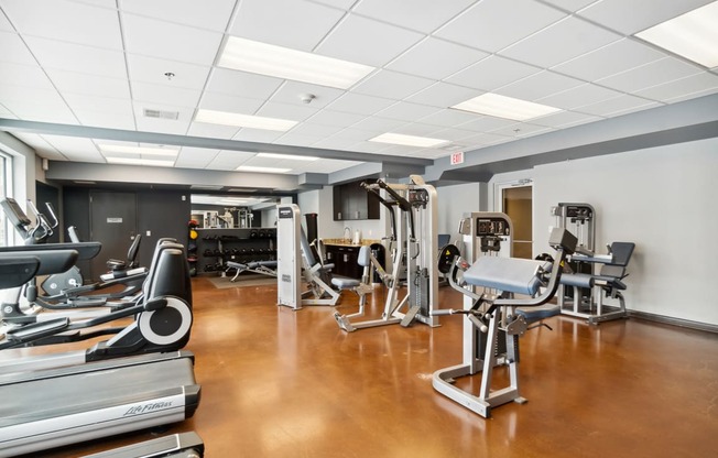 a room filled with lots of different types of exercise equipment