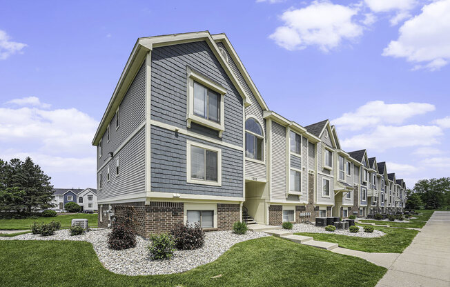 exterior apartment building with green lawn at The Crossings Apartments, Michigan, 49508