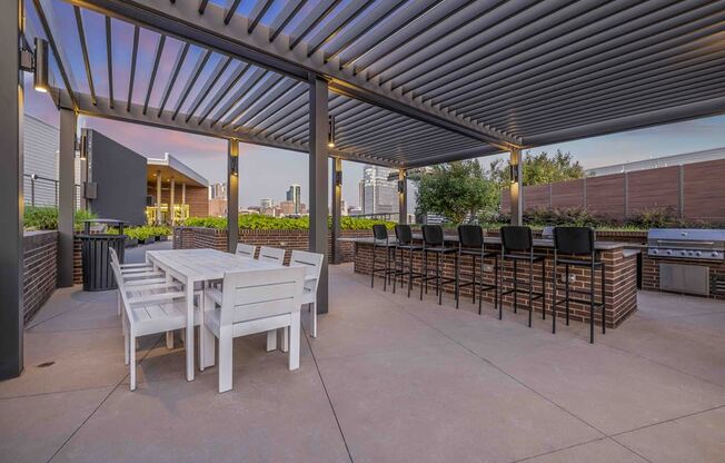 a patio with tables and chairs under awning