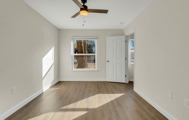 Addison Lane apartments in Gainesville, FL photo of a empty living room with a ceiling fan