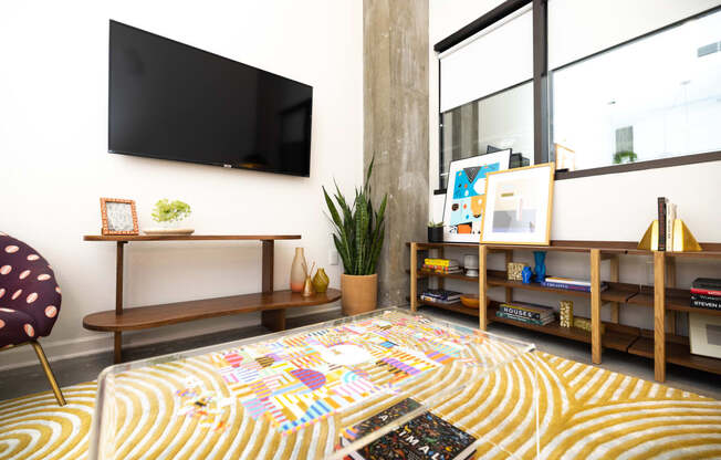 a living room with a bed and a television at The Lady, Columbia, South Carolina