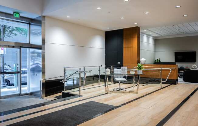 a conference room with a glass table and chairs and a large window