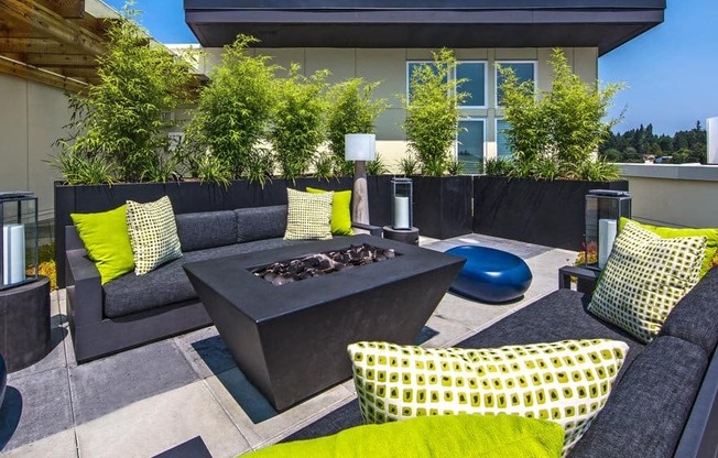 Seattle, WA, Apartments with In-Unit Washer and Dryer - Origin - Firepit with Lounge Seating and Outdoor Lamps on Rooftop Patio