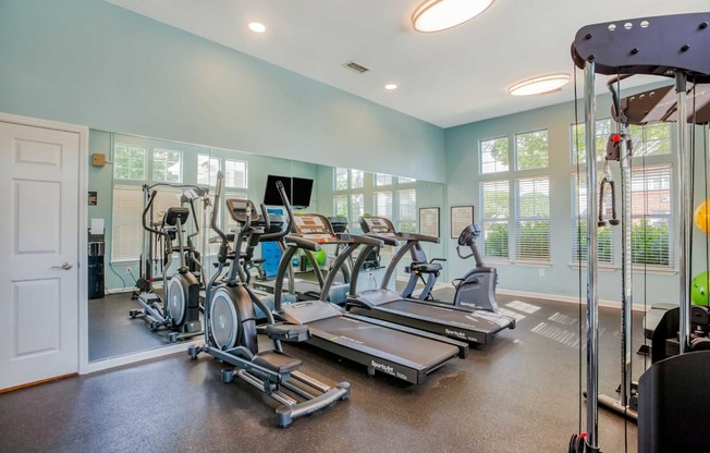 A spacious home gym with a variety of exercise equipment.