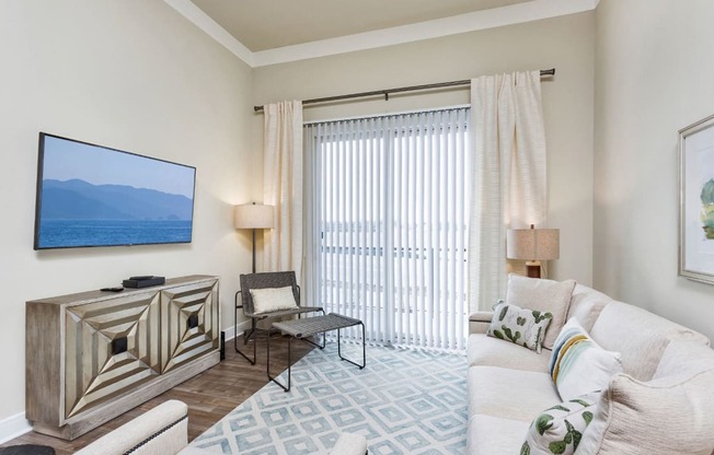 Westwood Green Apartments Living Room with faux wood floors and sliding doors to balcony