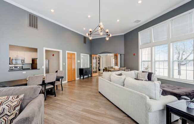 a living room with couches and chairs and a dining room table